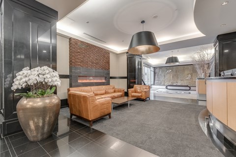 A modern reception with a fireplace and a large vase of flowers